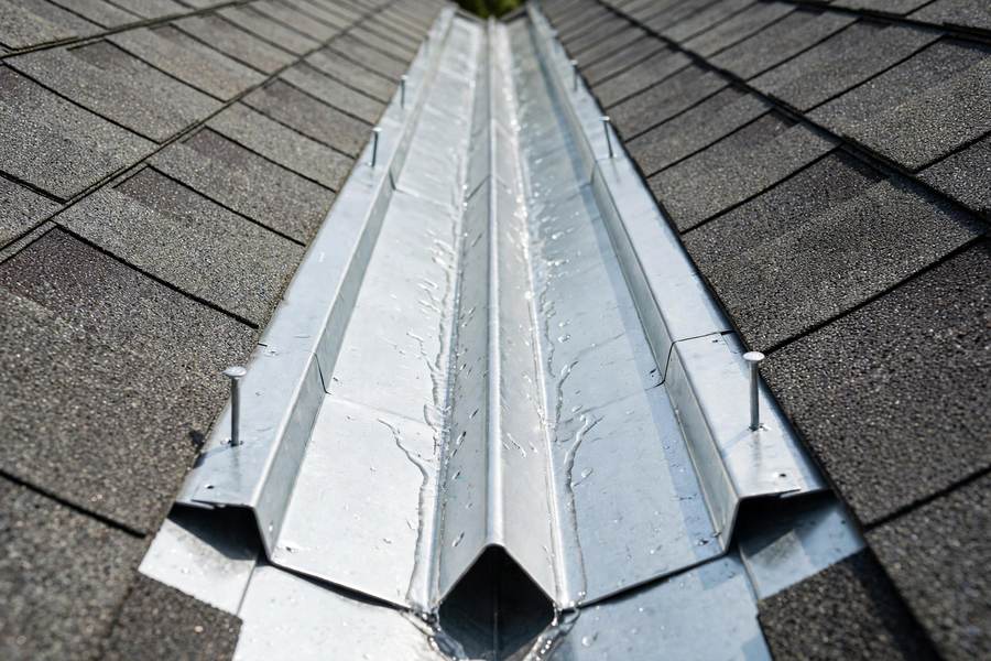 New metal valley flashing between two shingle roof slopes